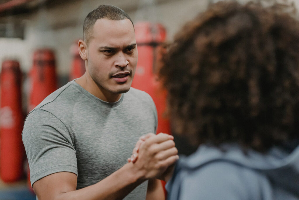 coach engaging customer at the gym