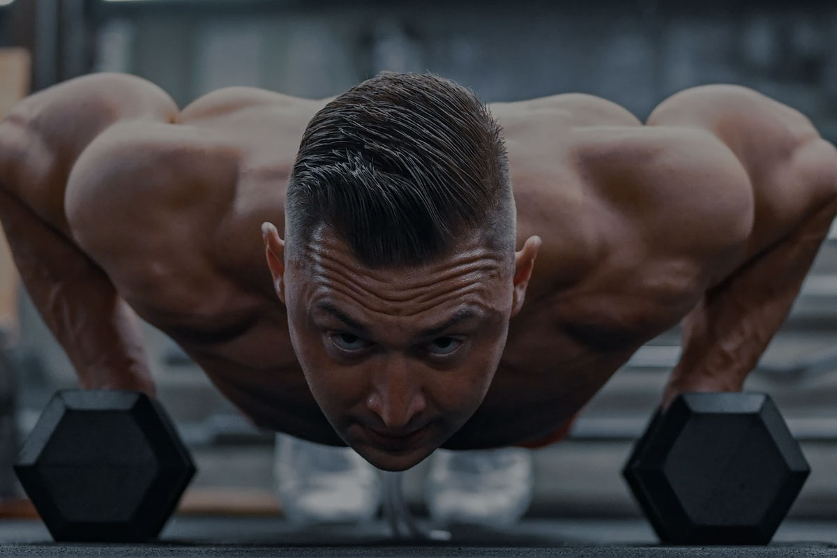 man doing a push up in a gym