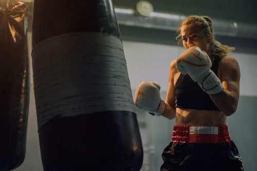 woman in black sports bra wearing a boxing gloves